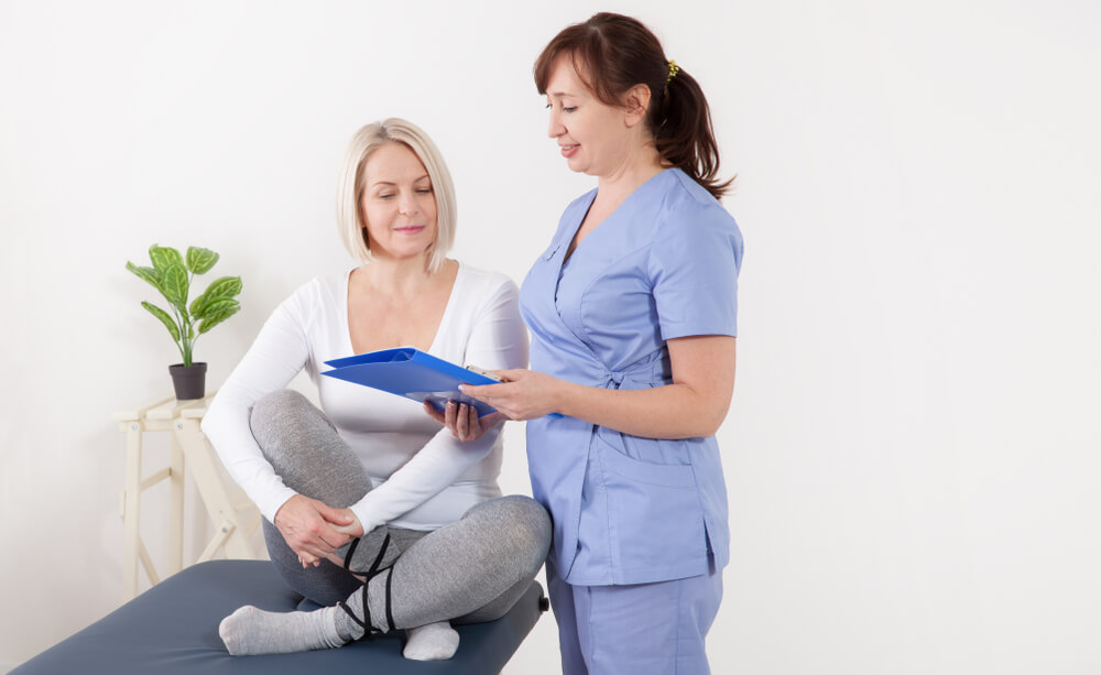 Female Patient and Doctor Have Consultation in Hospital.