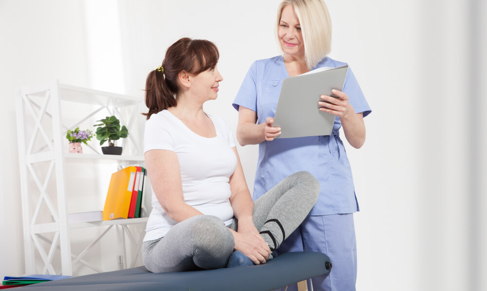 Female Patient and Doctor Have Consultation in Hospital.