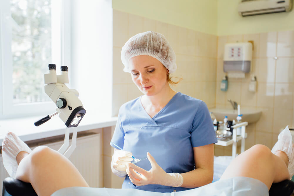 Woman Performing Vaginal Smear