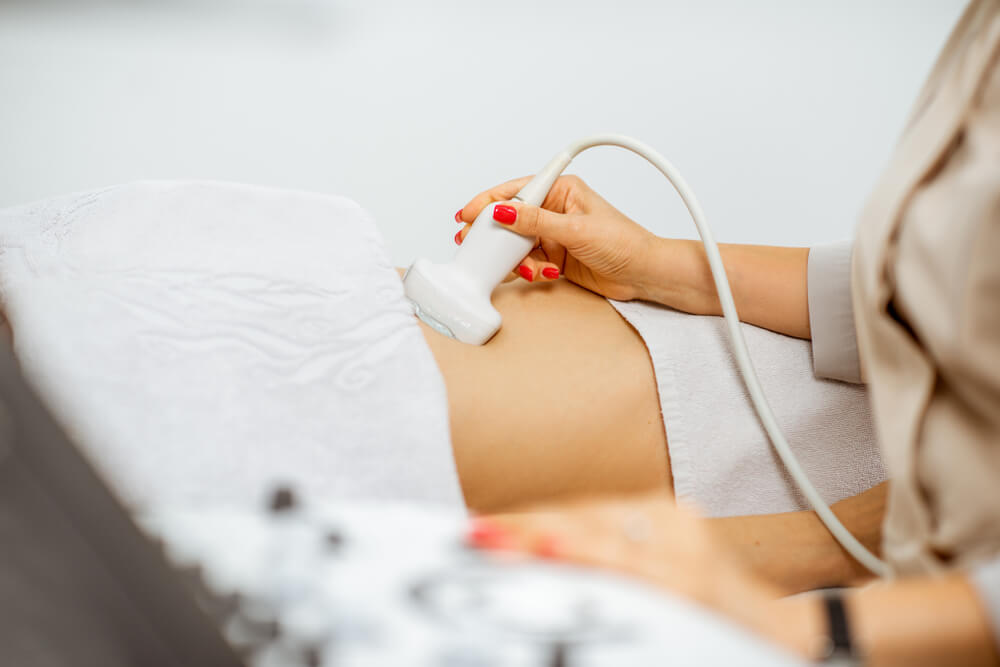 Doctor Conducting Ultrasound Examination of Pelvic Organs to Patient in Clinic Closeup