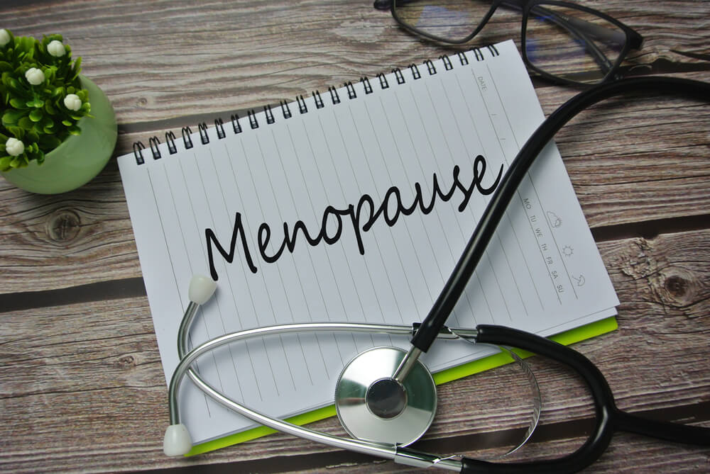 Selective Focus of Stethoscope and Notebook Written With Menopause.