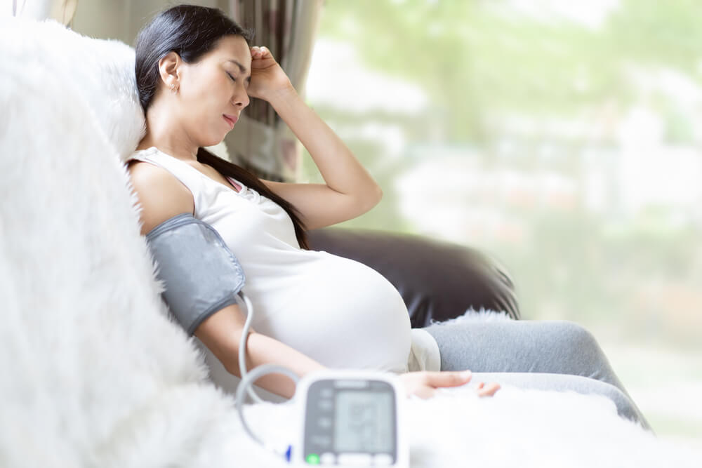 Asian Pregnant Woman Is Monitor Blood Pressure While She Has Headache to Prevent Hypertension During Pregnancy Period