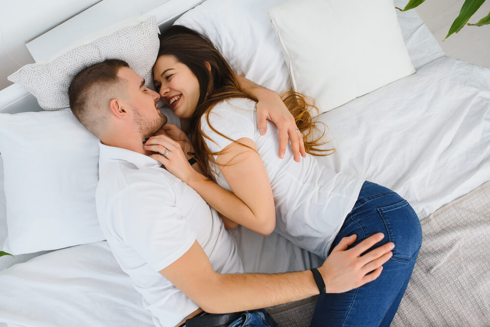 Young Loving Couple in the Bed