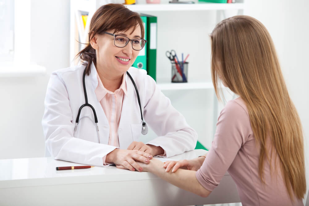 Doctor Explaining Diagnosis to Her Female Patient at Hospital