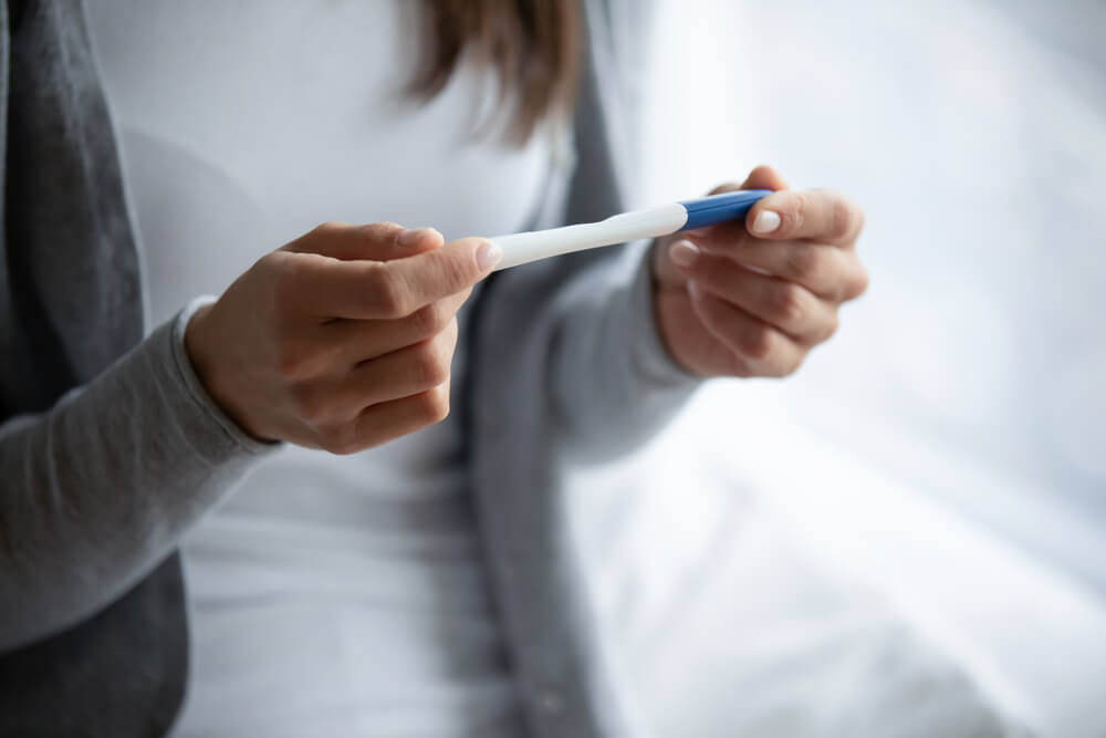 Close Up Cropped Image Woman Holding Plastic Pregnancy Test Kit in Hands