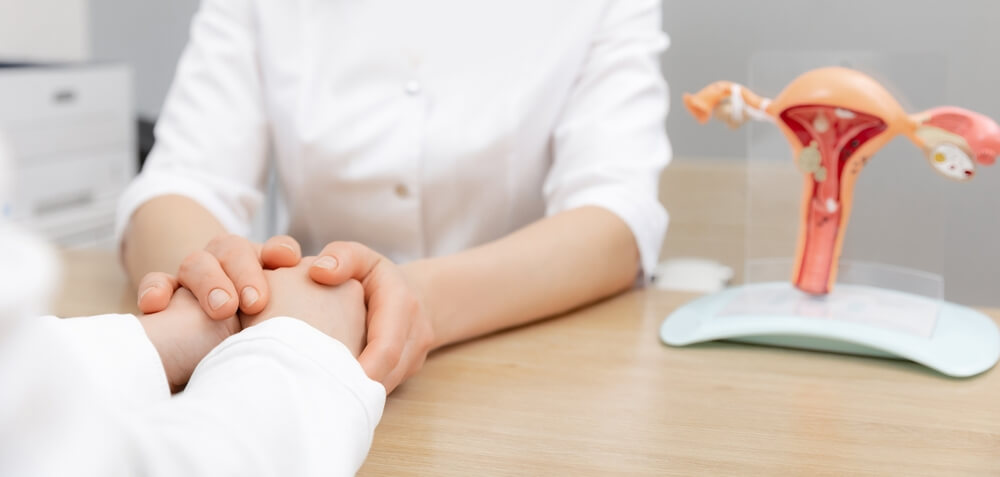 Gynecologist Woman Hold Hand of Young Female Patient During Medical Consultation in Modern Clinic