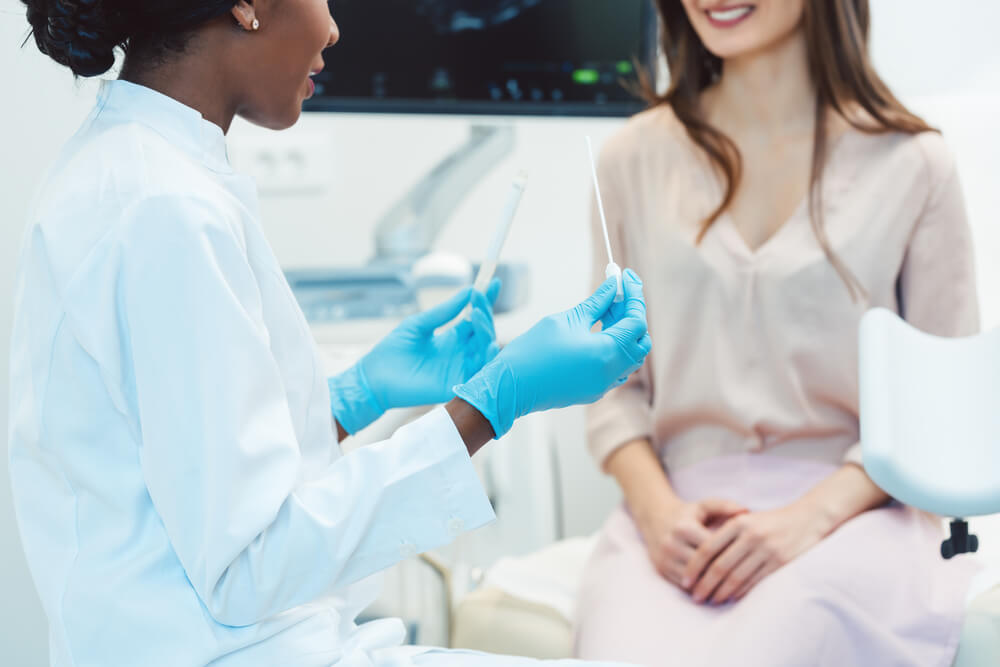 Woman Seeing Gynecologist Doctor in Her Office To Check for Std