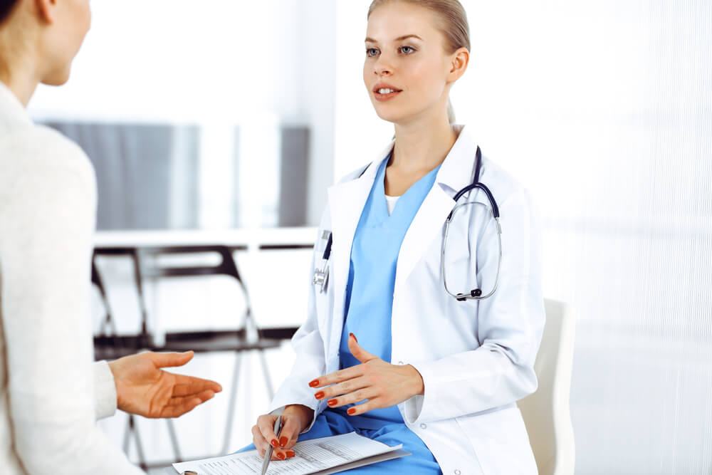 Woman - Doctor Consults Her Female Patient in Clinic. Medicine Concept