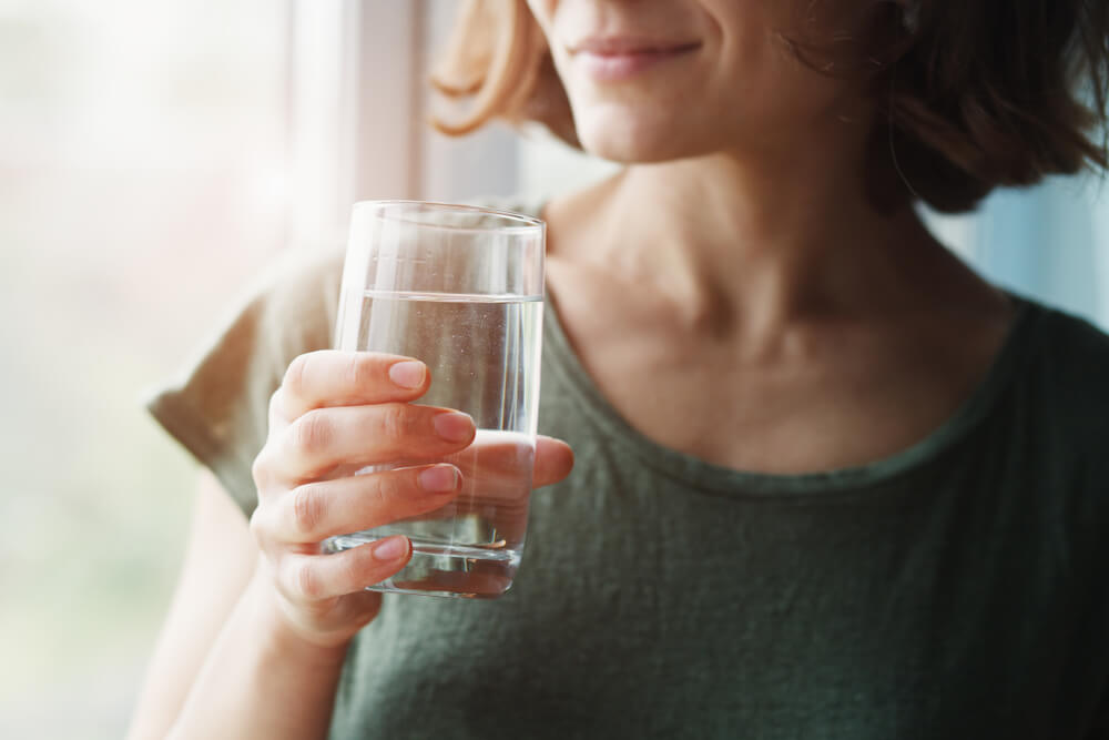 Healthy Beautiful Young Woman Holding Glass of Water