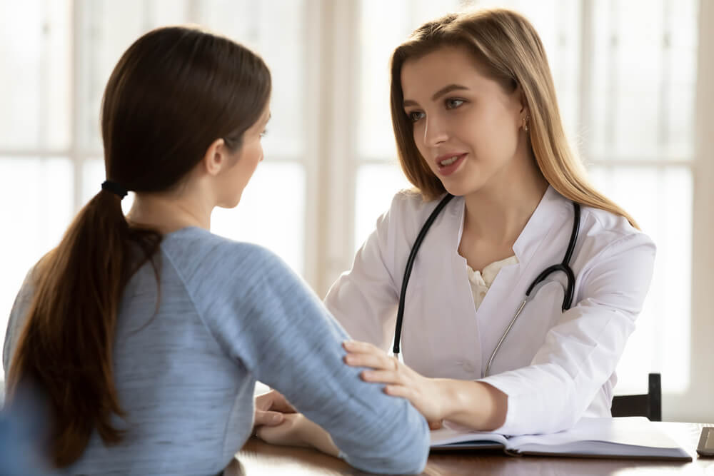 Understanding Caring Female Doctor Medical Practitioner Supporting Comforting Worried Anxious Young Woman Patient Client of Hospital