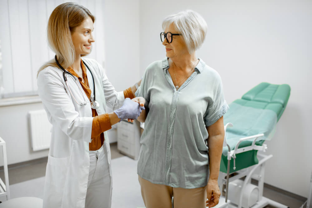 Gynecologist Taking Care of a Senior Woman Patient, Supporting and Cheering Her After the Examination in the Gynecological Office