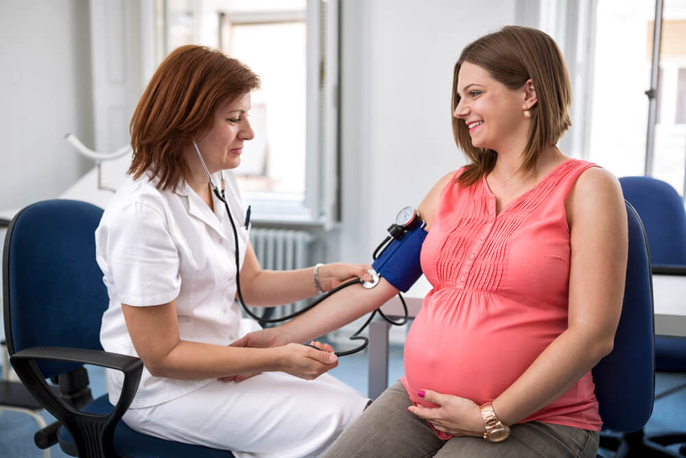 Nurse Measuring Pressure of Pregnant Woman