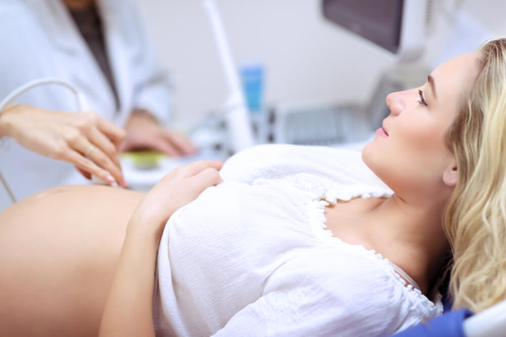 Pregnant Woman Doing Ultrasound Scan in the Prenatal Clinic, Mother Worried About Health of Her Future Baby, Happy Pregnancy Time