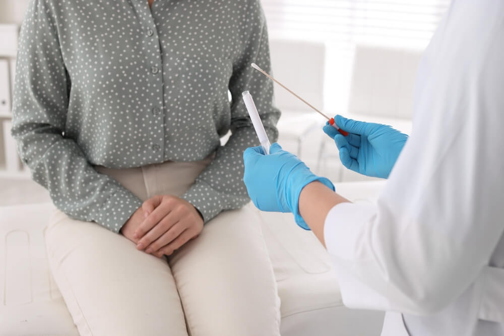 Doctor Taking Sample for Std Testing From Woman in Clinic Closeup