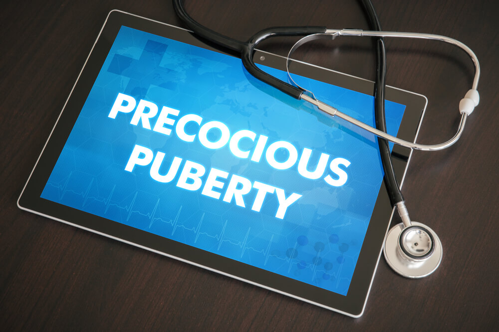 Precocious Puberty Endocrine Disease Related Diagnosis Medical Concept on Tablet Screen With Stethoscope