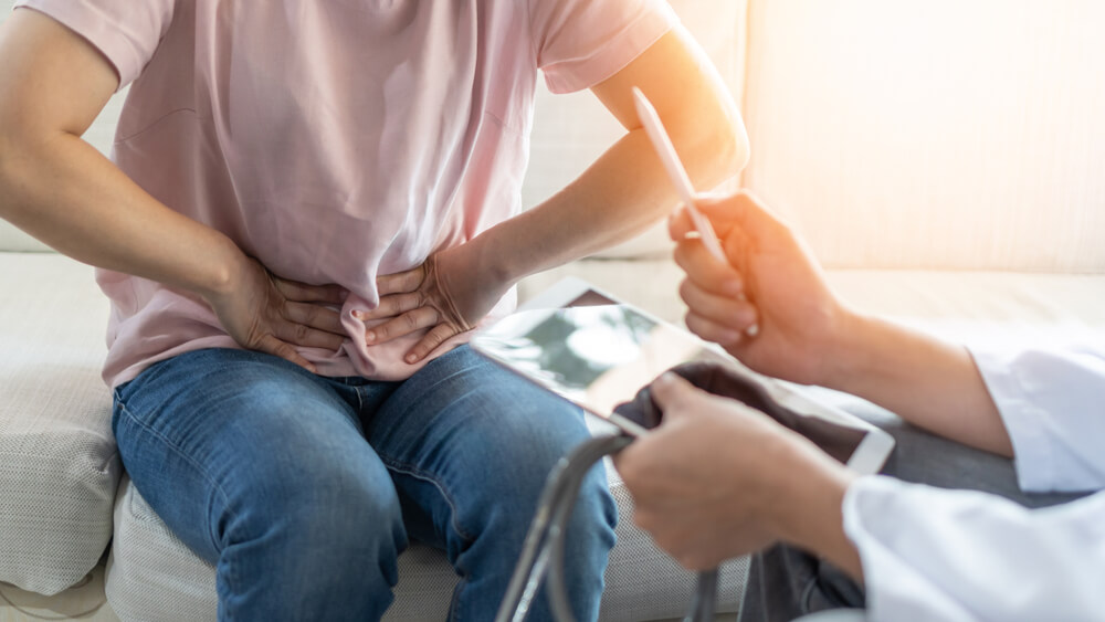 Abdominal Pain Patient Woman Having Medical Exam With Doctor on Illness From Stomach Cancer