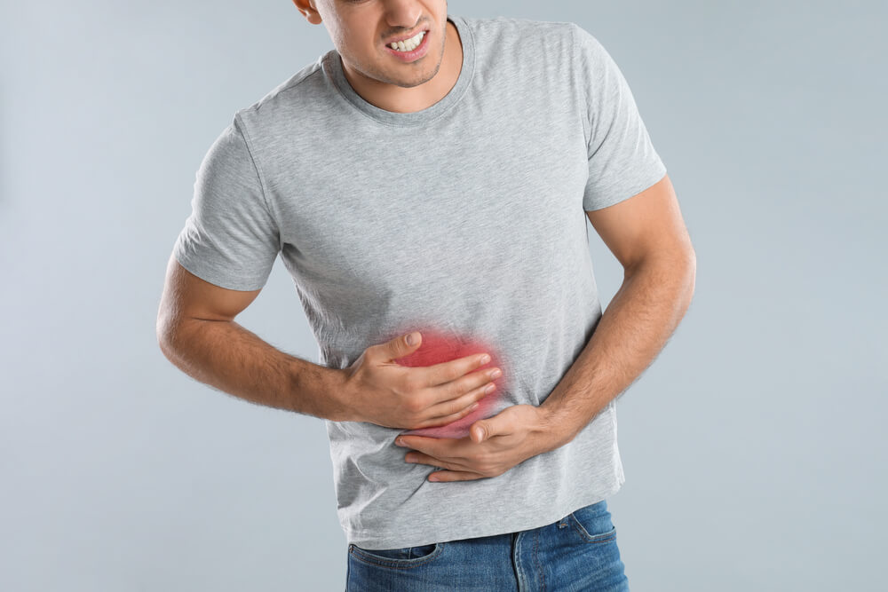 Man Suffering From Liver Pain on Grey Background