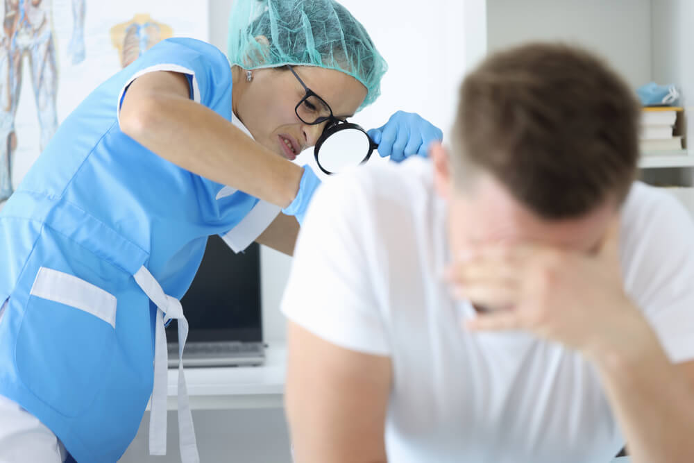 Doctor With Magnifying Glass Examines a Man’s Rectum 