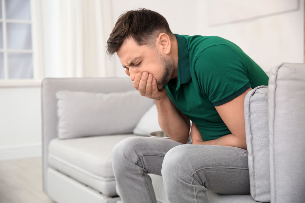 Young Man Having Nausea at Home.