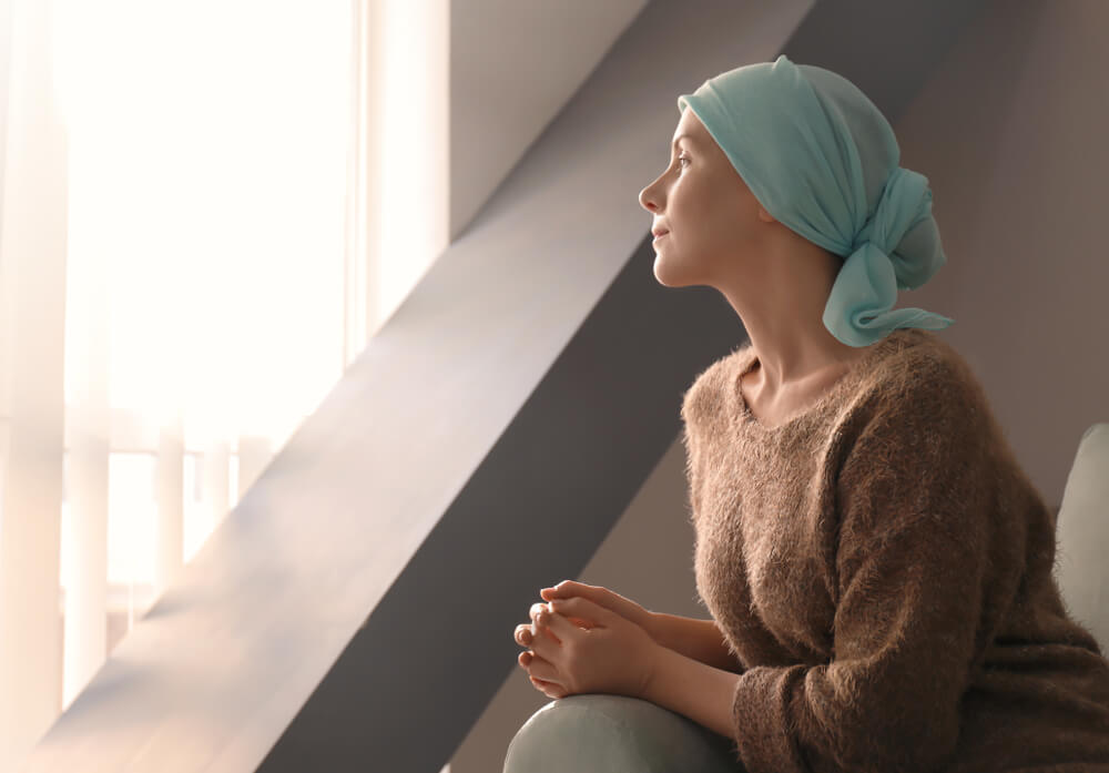 Young Woman With Cancer in Headscarf Indoors