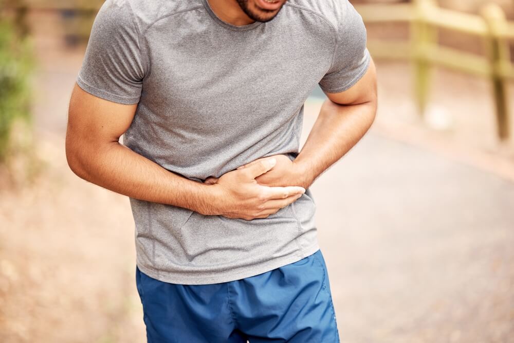 Fitness Stomach Ache and Man Outdoor After Running Workout or Exercise