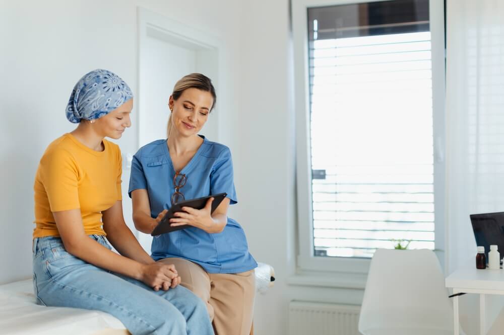 Oncologist treating a patient with cancer and provide emotional support.