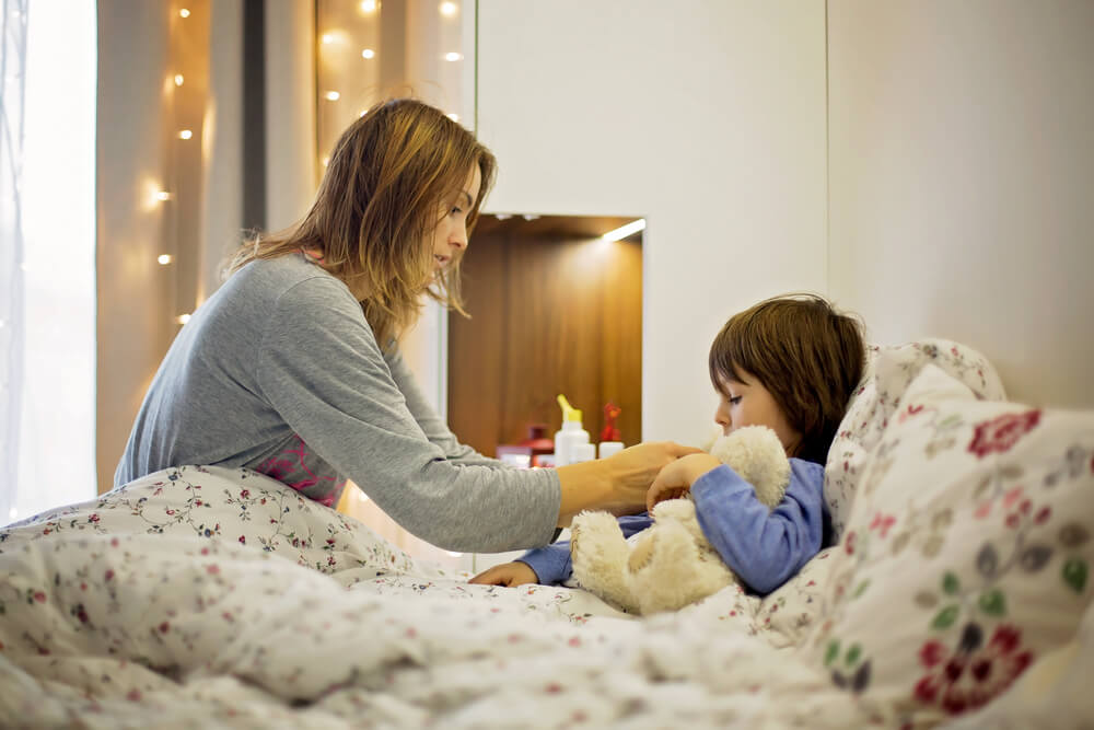 Cute Sick Child, Boy, Staying in Bed, Mom Giving Him Medicine and Checking for Fever