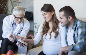 Doctor visiting pregnant patient at home Doctor visiting pregnant patient at home