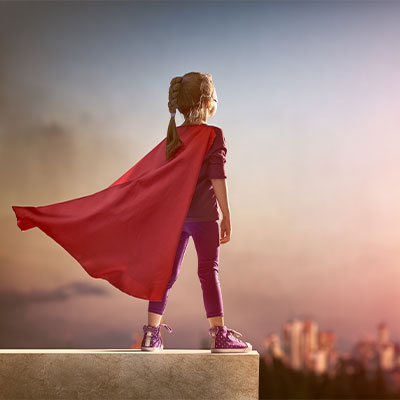 Girl Dressed Like a Superman Looking Into Distance