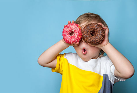 Kid making Glasses Out of Donuts