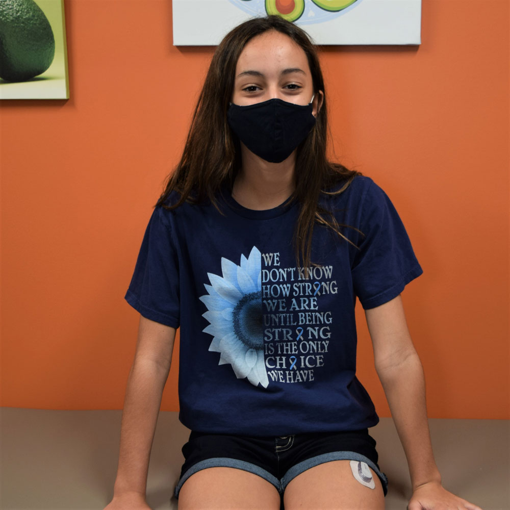 Teen Girl Wearing a Face Mask While Sitting in a Waiting Room
