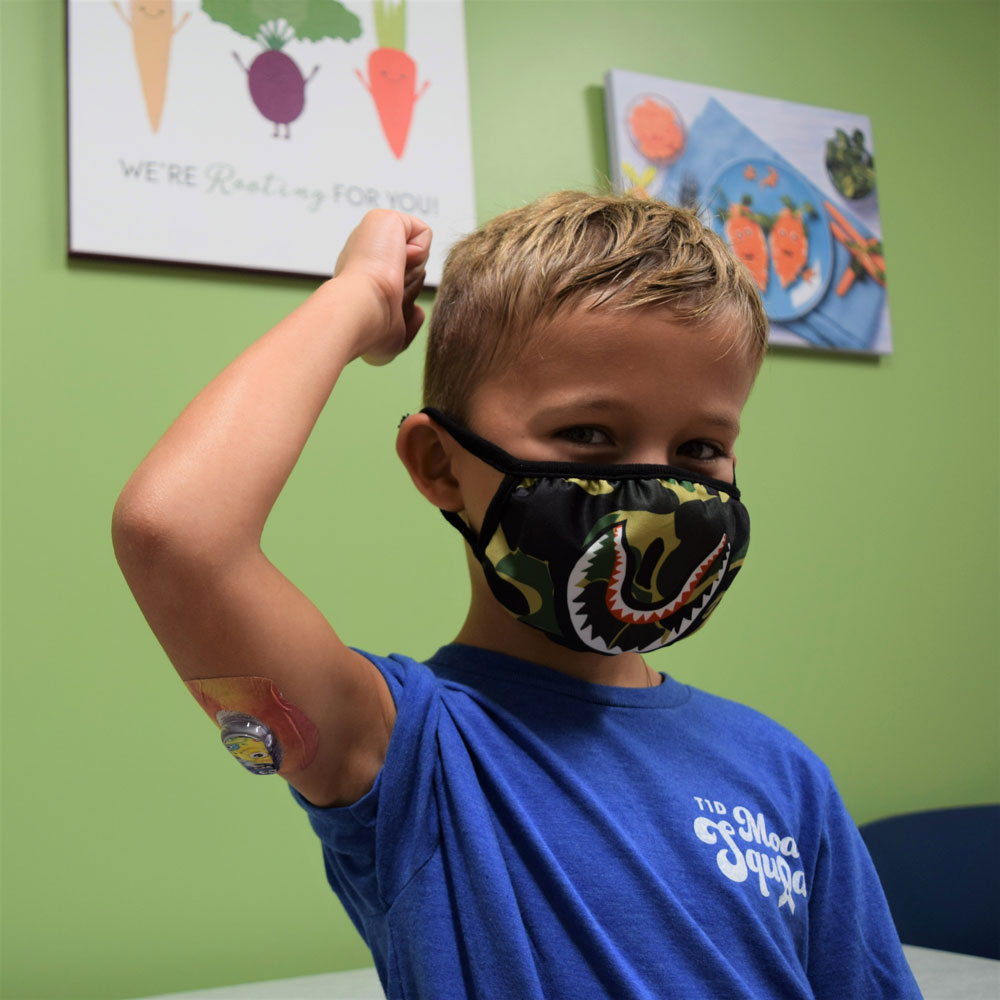 Young Boy In Blue Shirt Wearing a Face Mask