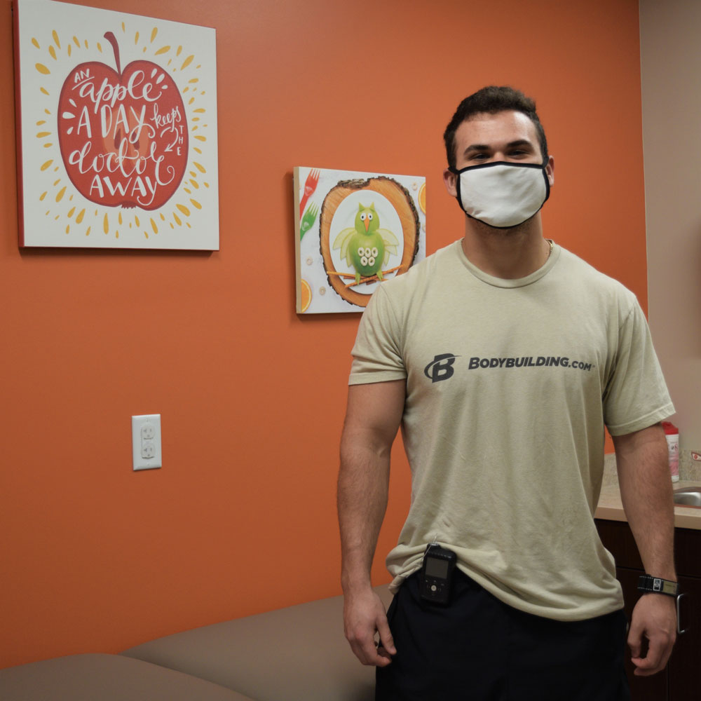 Fit and Pumped Man in Front of a Orange Wall