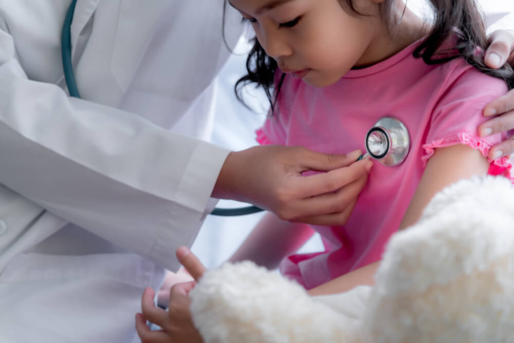 Asian Female Doctor Is Using a Stethoscope Listen to Heart Rate of a Little Girl