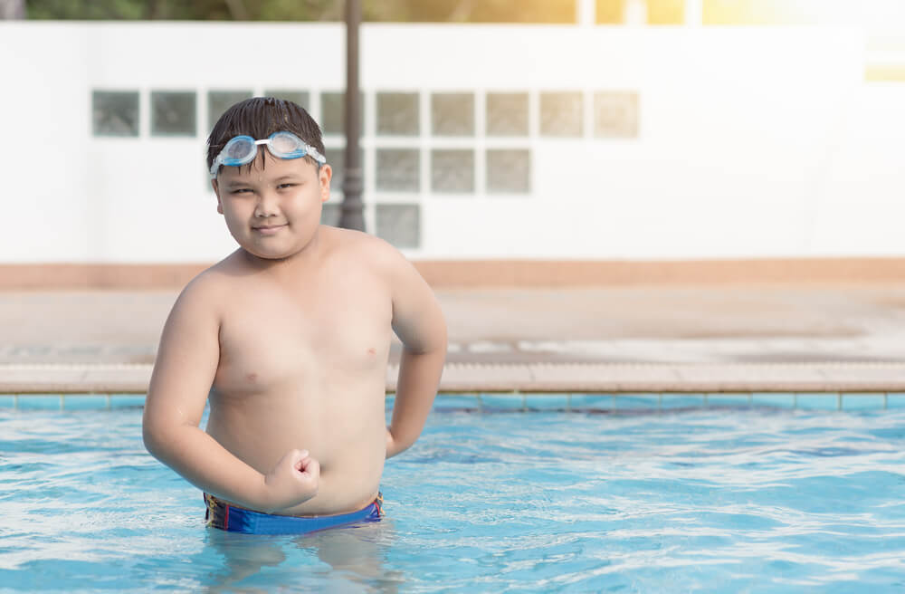 Obese Fat Boy Show Muscle in Swimming Pool, Concept Healthy and Exercise