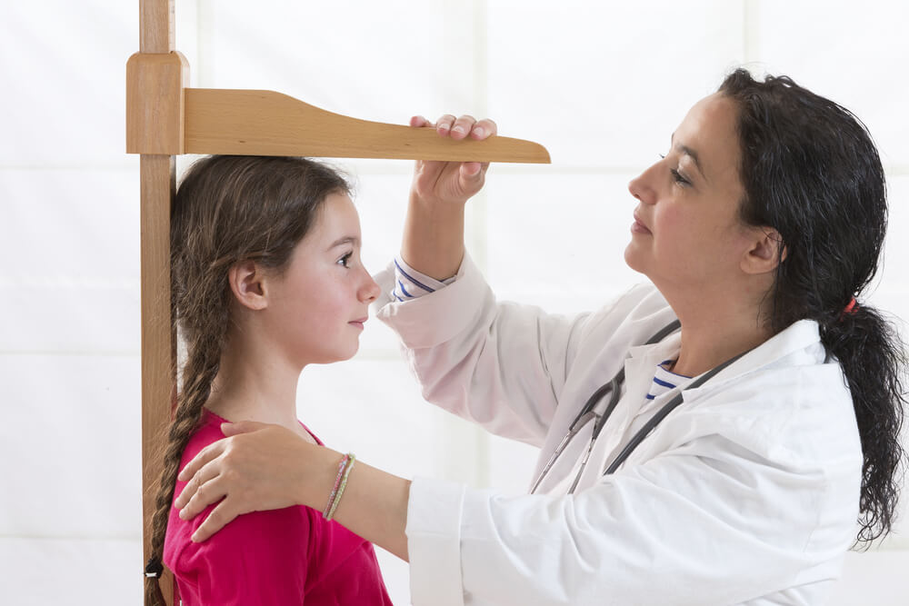 Doctor Measuring Little Girl’s Height