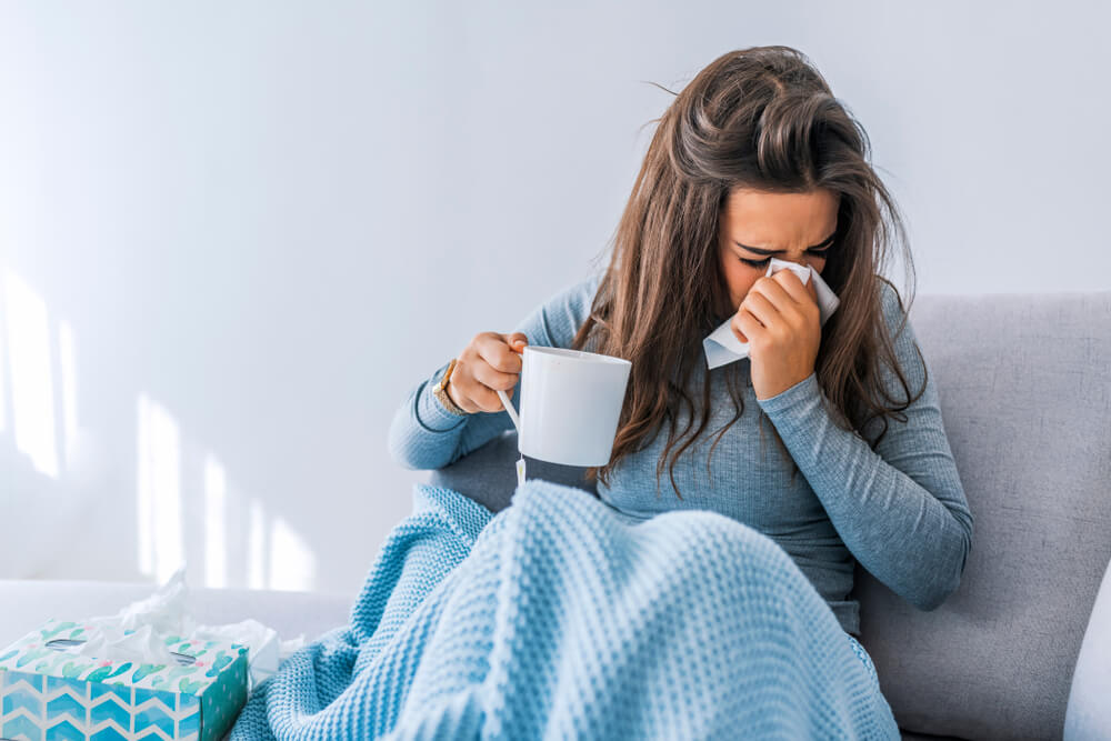 Sick Woman With Headache Sitting Under the Blanket.