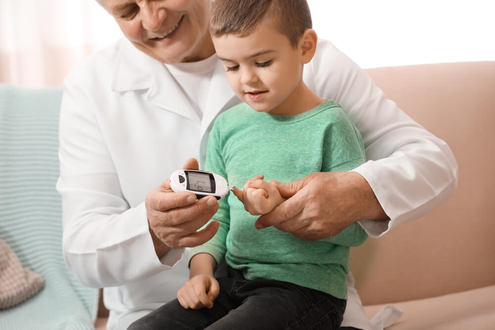 Doctor Measuring Patient’s Blood Sugar Level With Digital Glucose Meter at Home.
