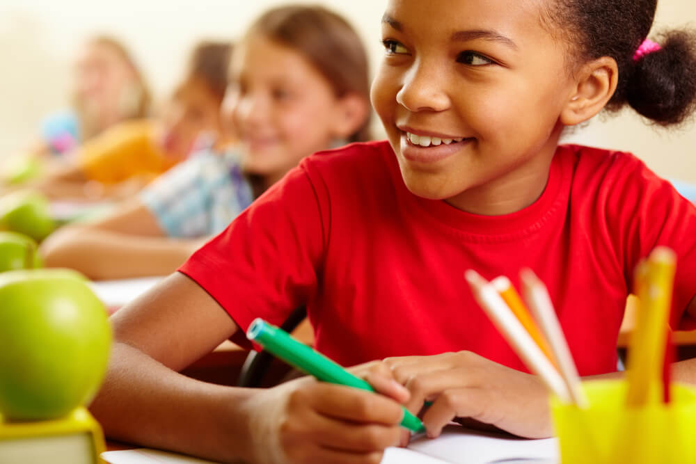 Row of Pupils Looking at Teacher With Cute Girl in Front