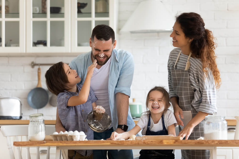 Overjoyed Young Family With Little Preschooler Kids Have Fun Cooking Baking Pastry