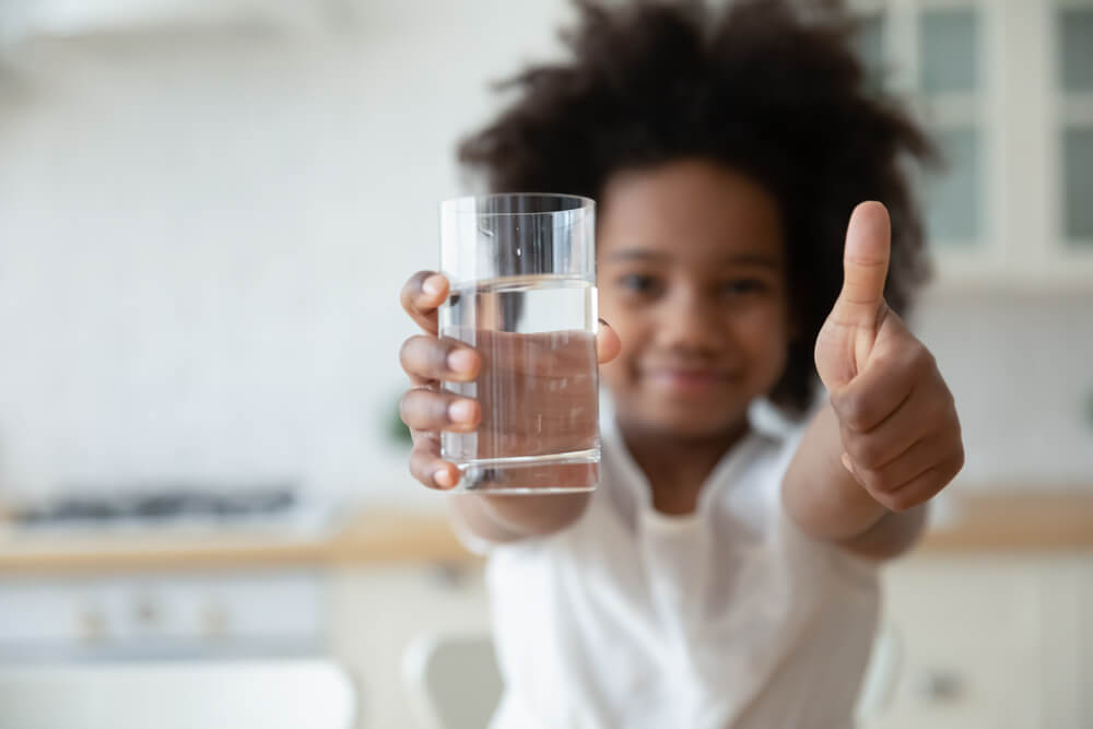 Focus on Happy Small African American Girls Hands Holding Glass With Fresh Pure Water and Showing Thumbs up Gesture.