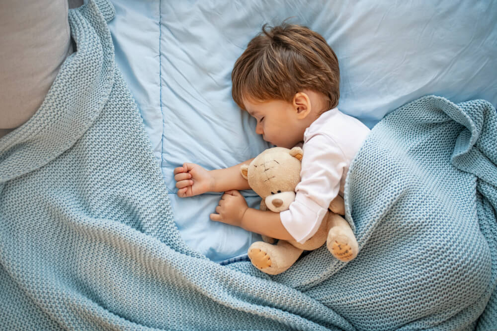 Baby Boy Sleeping Together With Teddy Bear.