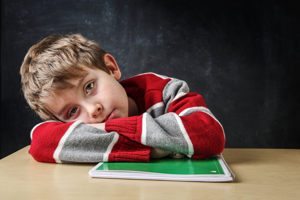 Bored Student Laying His Head on His Desk