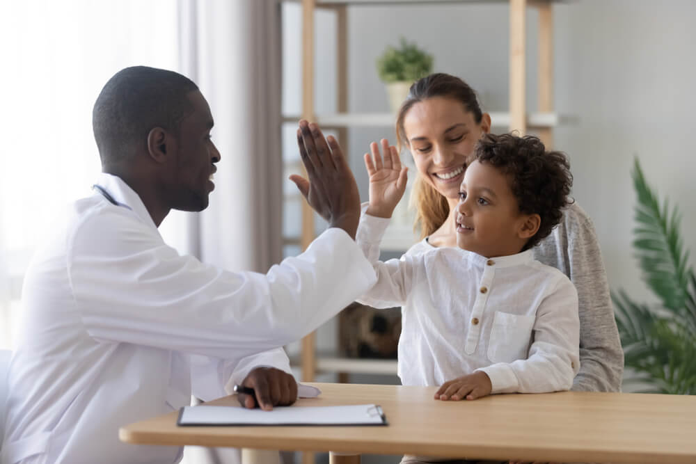 Boy Give High Five To African Man Pediatrician Welcome Little Patient and Mom at Consultation