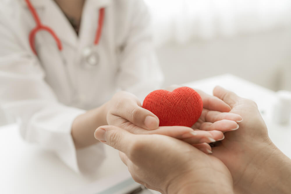 Doctor and Patient Hands Holding Red Heart, Health Care Love, Give, Hope and Family Concept, World Heart Day, World Health Day