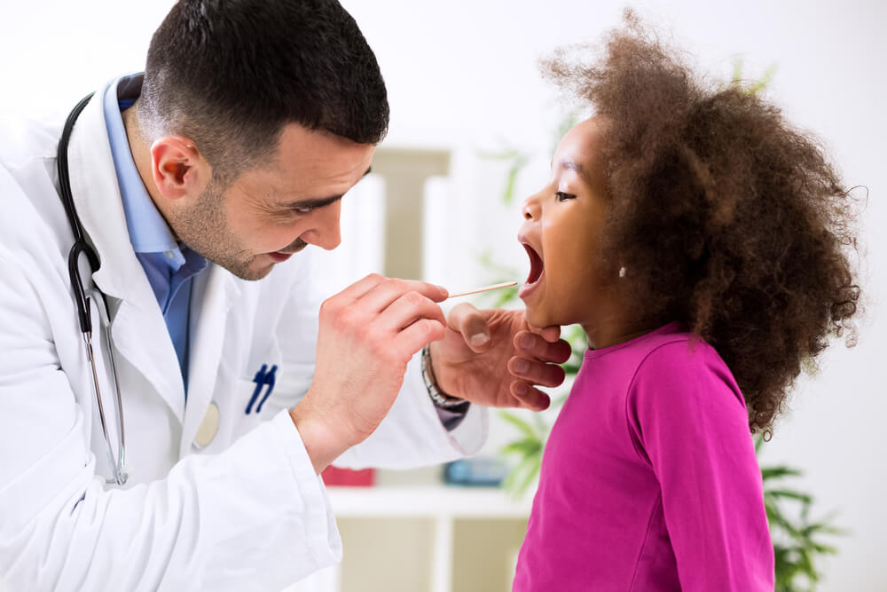Doctor Pediatrician Examining Cute Smiling African Girl Throat Sick