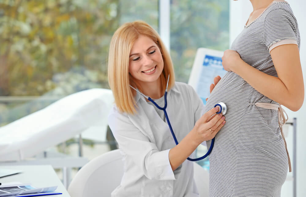 Closeup of Doctor Examining Pregnant Woman in Hospital