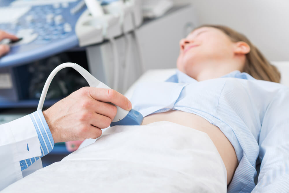 Doctor Doing Ultrasound Screening Checkup in Clinic Office