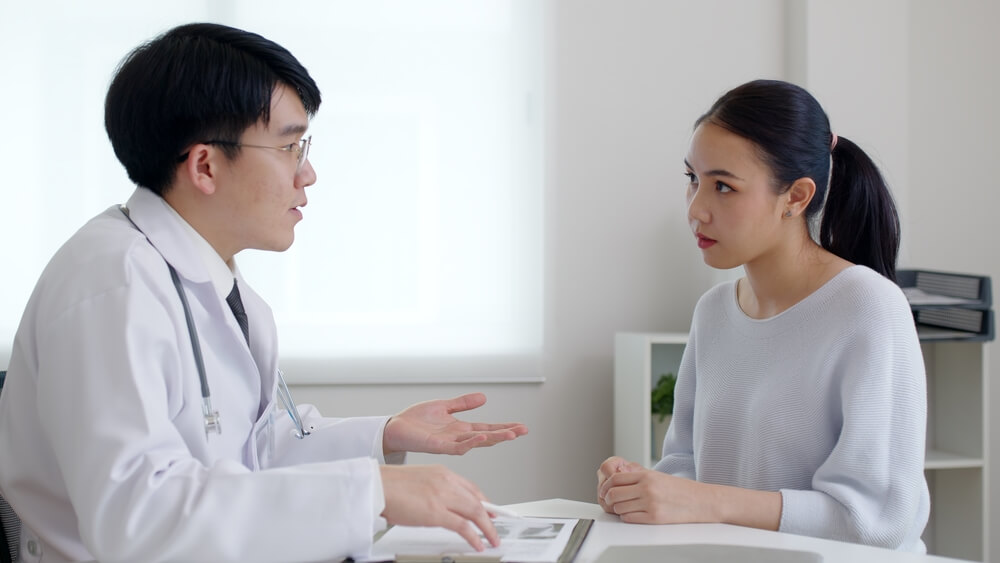 Young Lady Client Patient Visiting Pleasant Attentive Female Doctor Physician at Modern Clinic Medical Center, Listening to Detailed Recommendations of Qualified Specialist