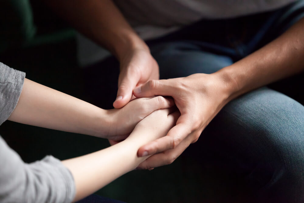 Close up View of Couple Holding Hands, Loving Caring Man Supporting Comforting Woman